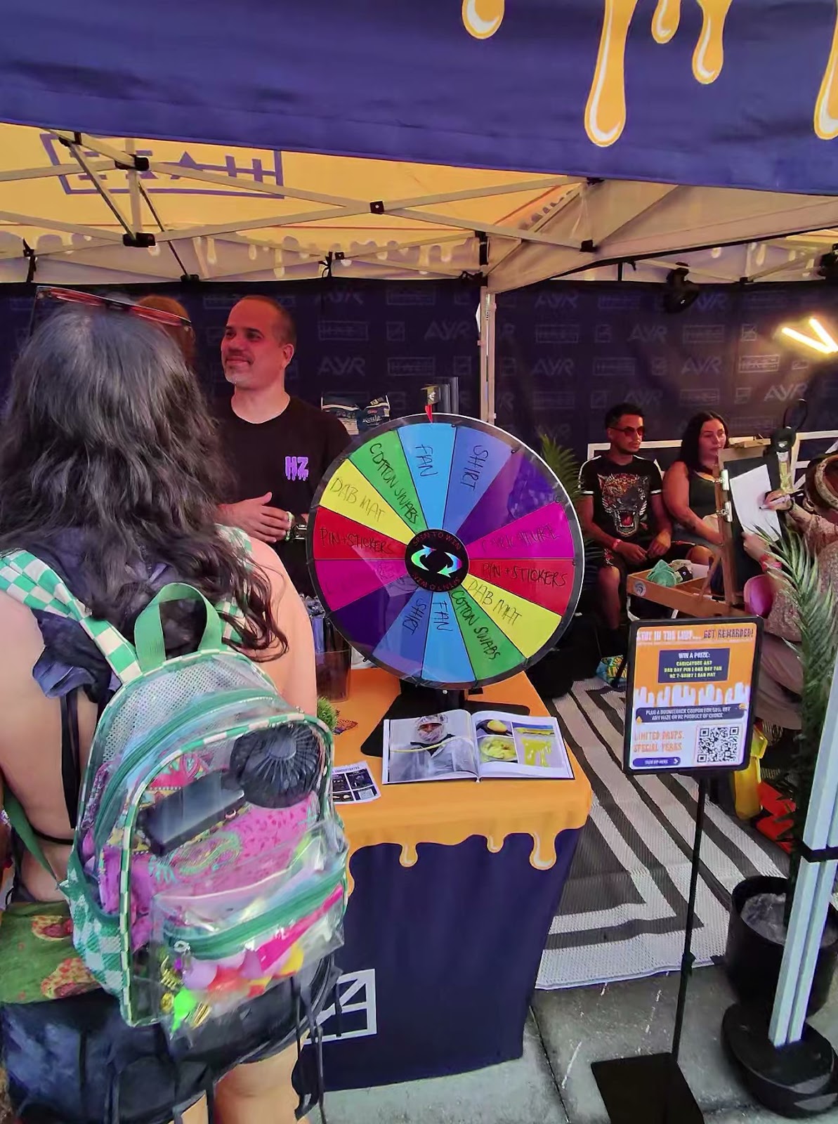 Prize wheel booth with AVR branding and free swag at 710 Dab Day