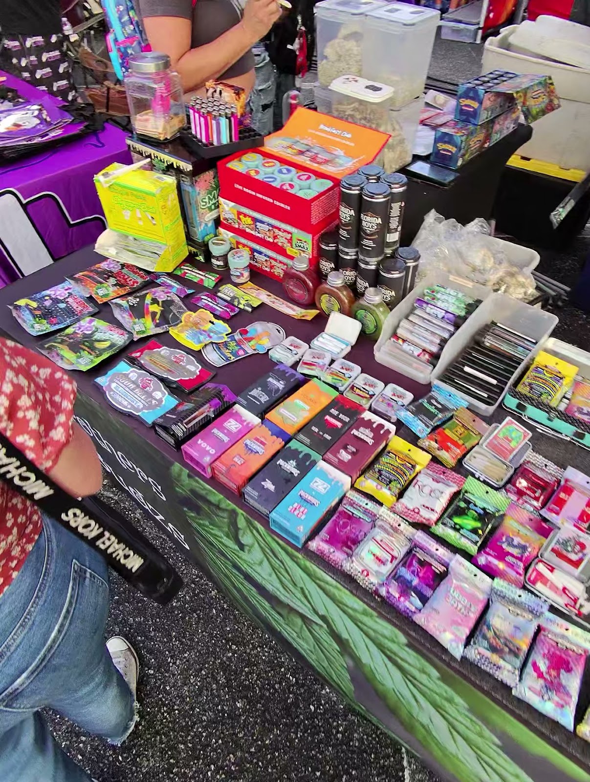 Cannabis vendor table with concentrates, drinks, and product samples at 710 Dab Day