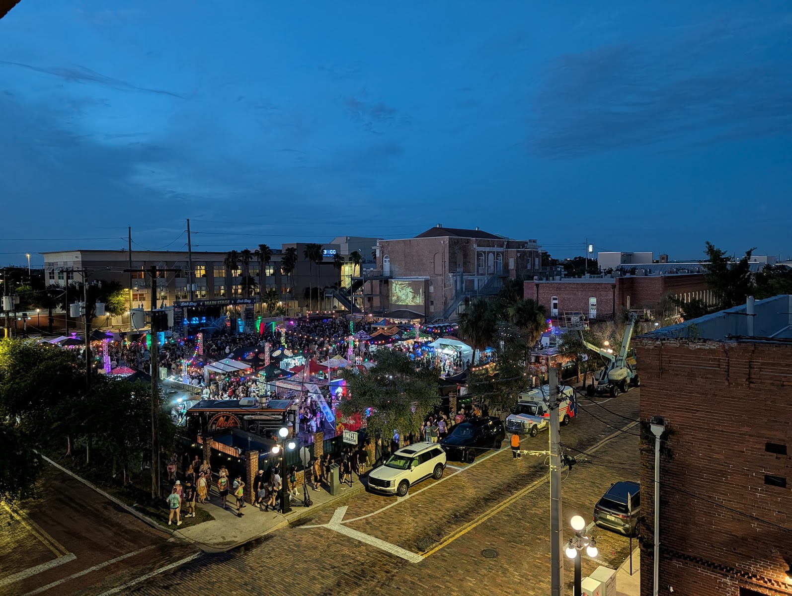 Nighttime high-angle view of 710 Dab Day vendor tents and crowd
